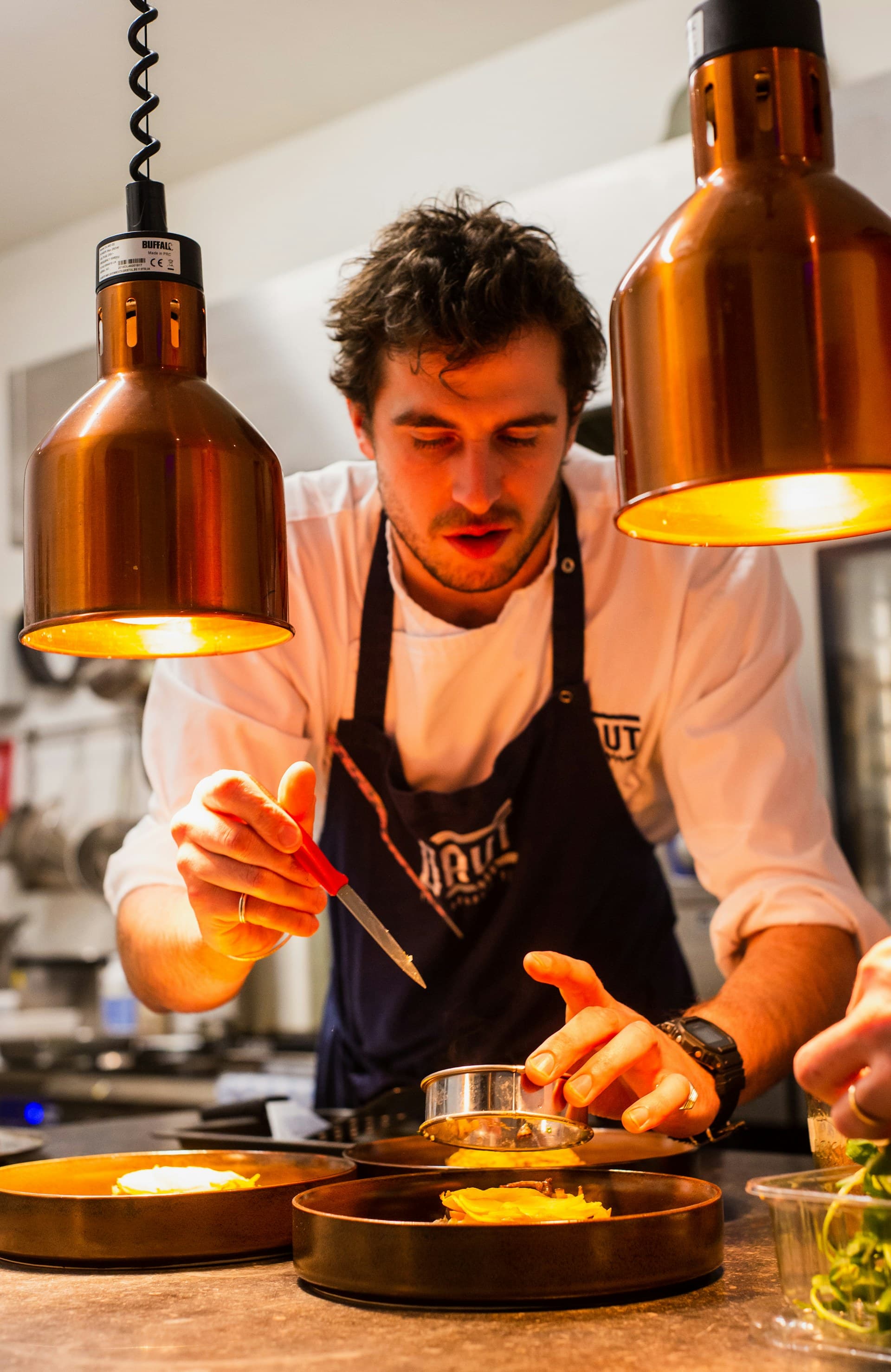 A chef plating a farm-driven tasting course in a Wine Country kitchen