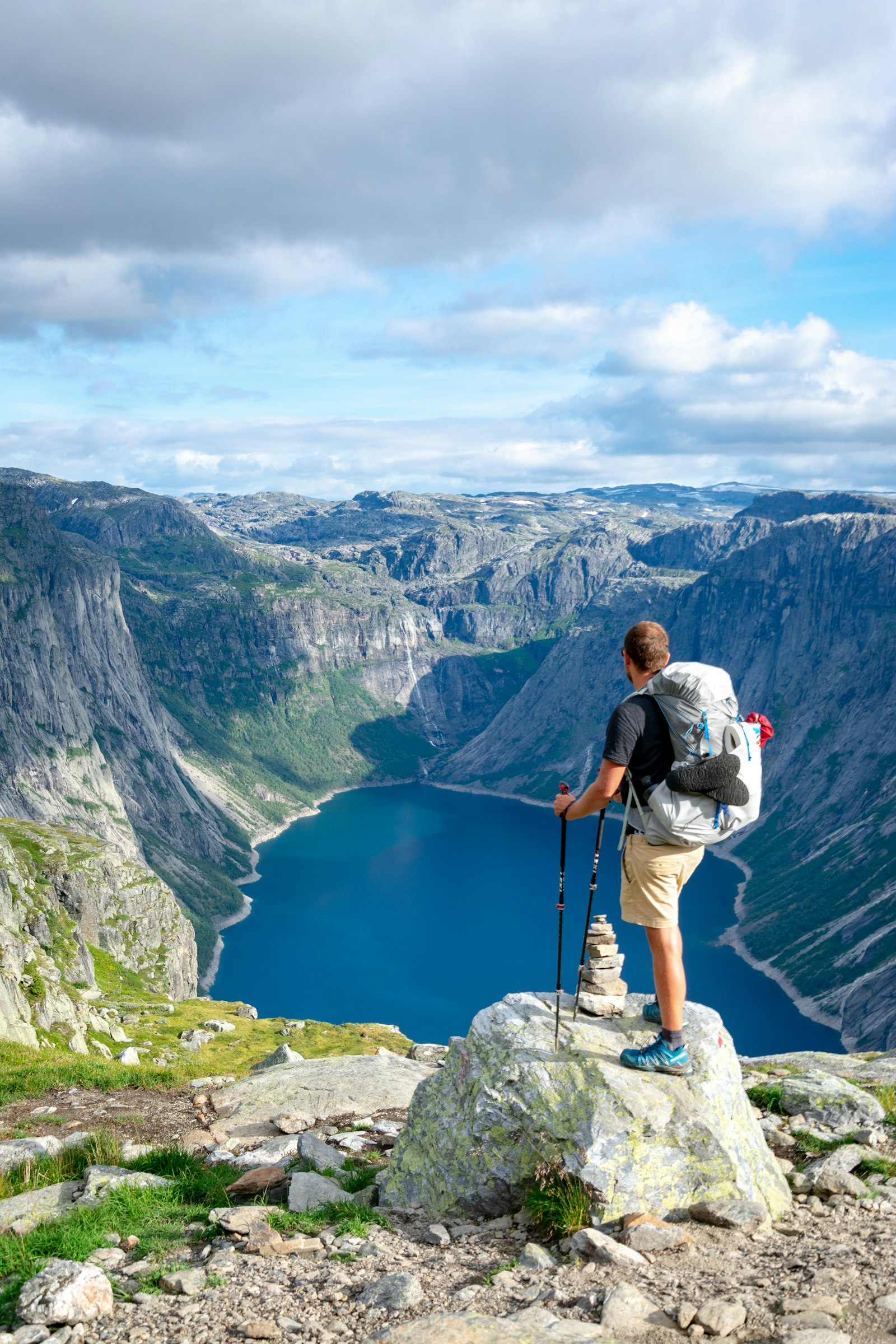 A solitary figure pausing on a quiet trail above a vast valley at dawn