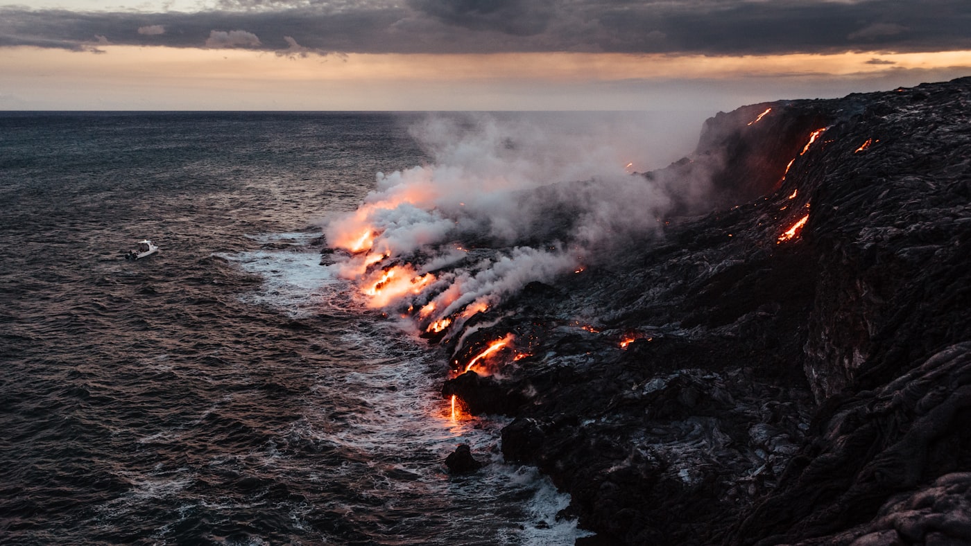 The volcanic coastline of the Big Island under a bright sky