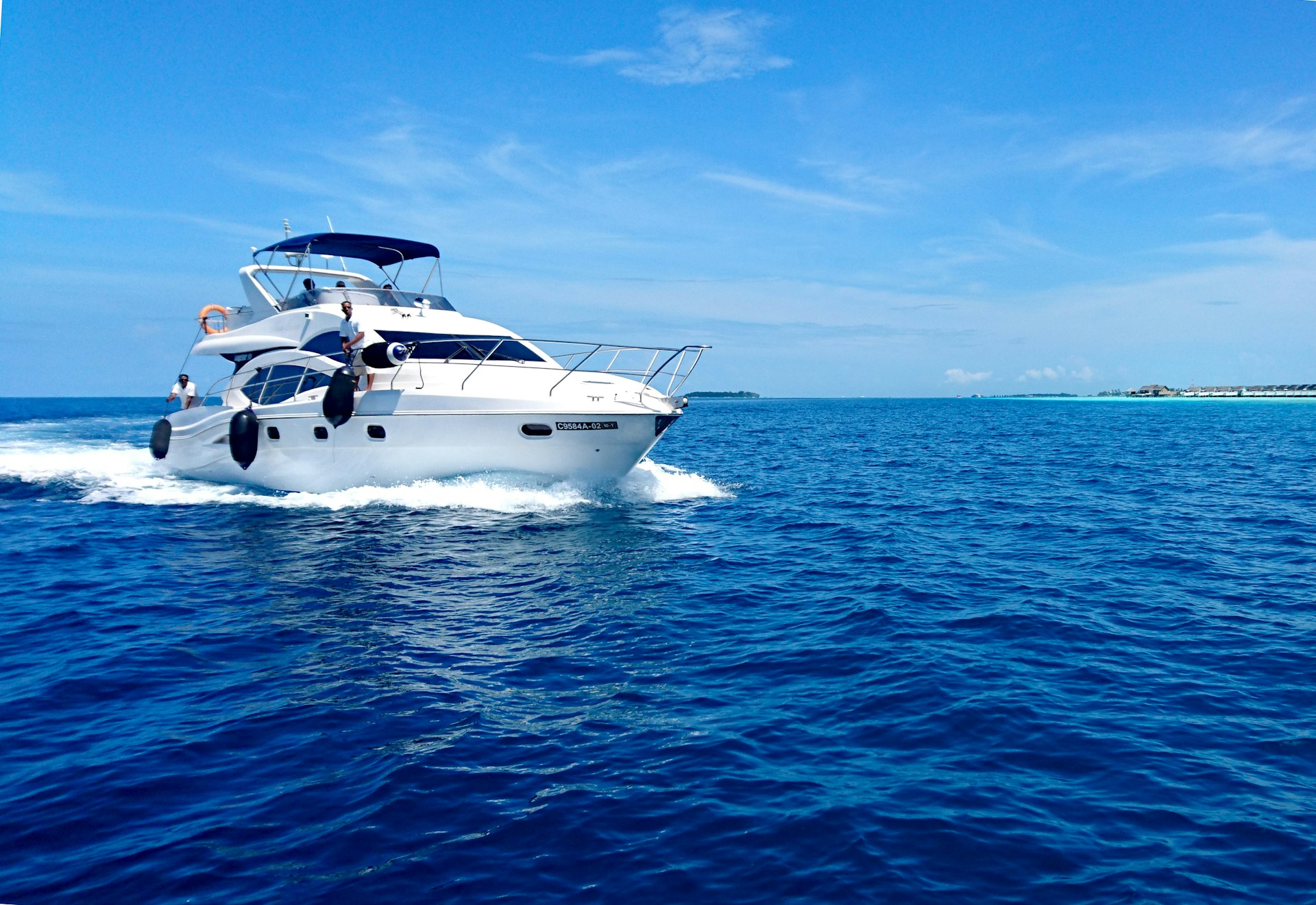 A boat on calm turquoise water under a clear sky in the Florida Keys